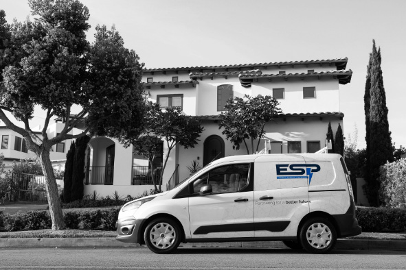Energy Service Partners Van in a color pop style in front of a California home