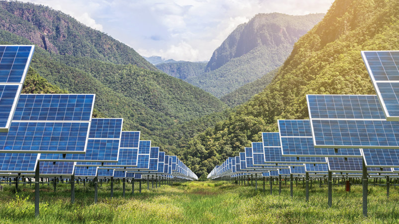 Sunny mountain view behind solar farm